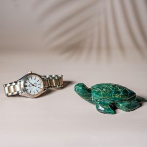 Semi precious stone turtle sculpture shown for size reference