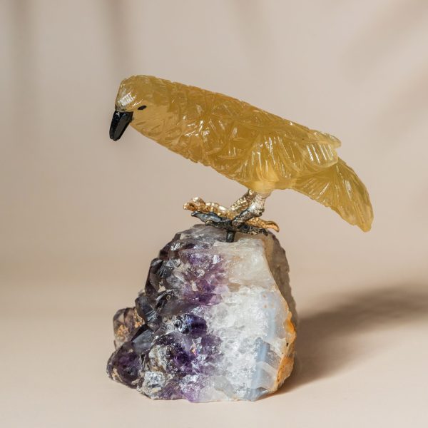 Side profile of hand carved semi precious stone bird sculpture