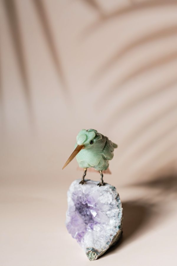 Green calcite bird figurine on natural amethyst crystal base for luxury home decor and gifting