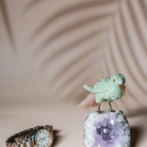 Green calcite bird figurine on natural amethyst crystal base for luxury home decor and gifting
