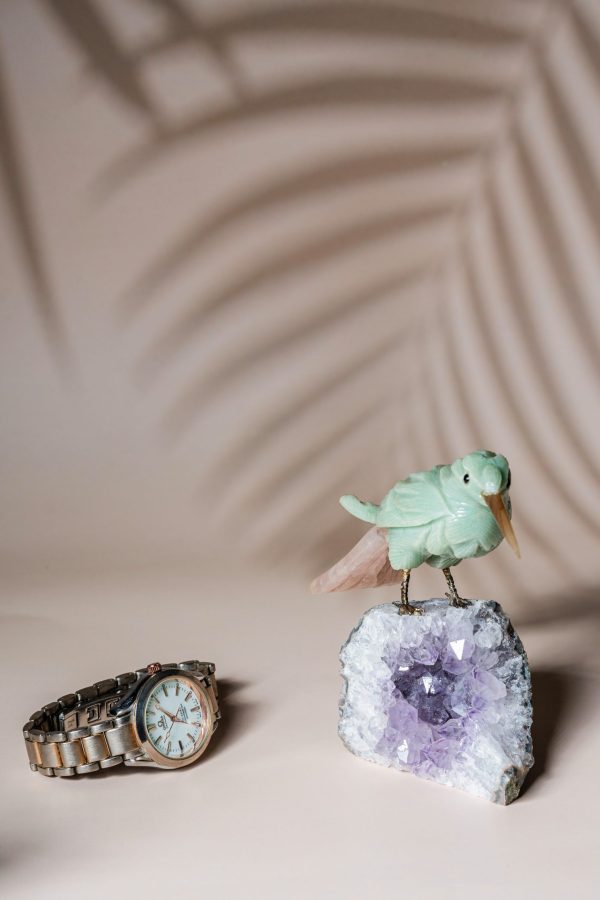 Green calcite bird figurine on natural amethyst crystal base for luxury home decor and gifting