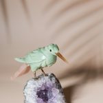 Green calcite bird figurine on natural amethyst crystal base for luxury home decor and gifting