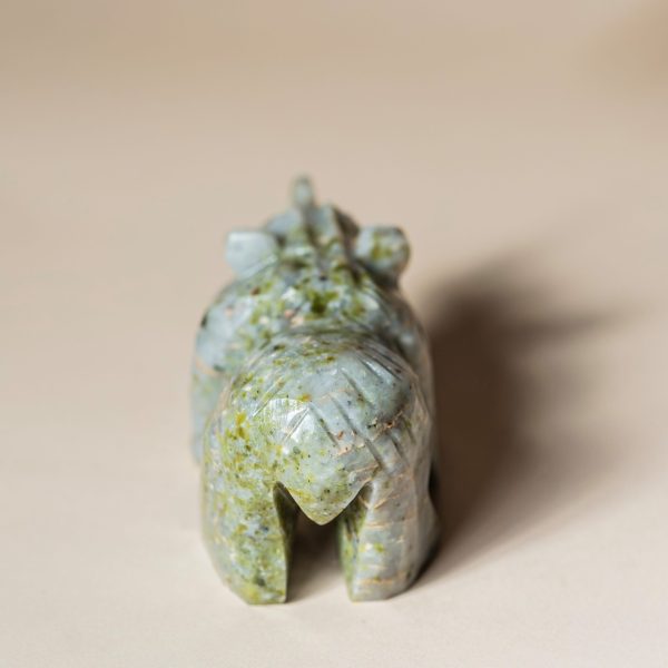 Back view of handcrafted jade bear sculpture showing smooth stone carving