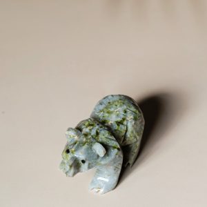 Side view of light green jade bear figurine carved from natural jade stone