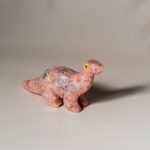 Handcrafted pink granite dinosaur figurine made from semi precious stone