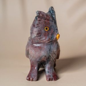 Close-up of purple jasper owl gemstone carving details