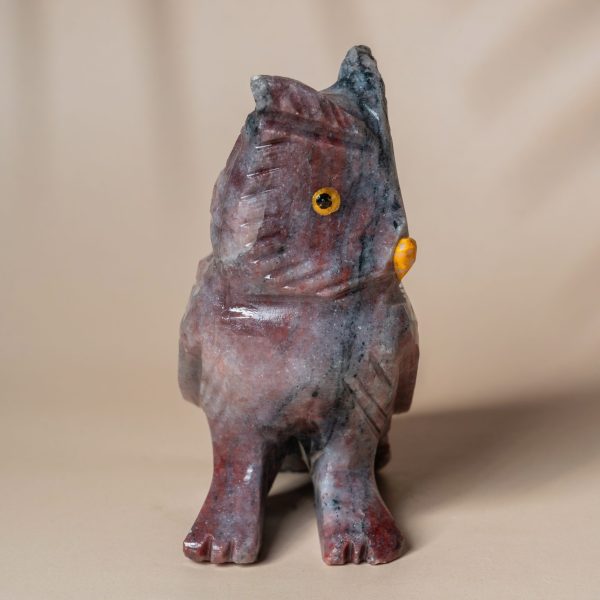 Close-up of purple jasper owl gemstone carving details