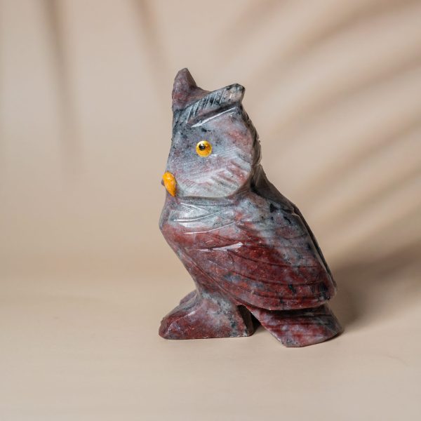 Side view of handcrafted purple jasper owl stone sculpture