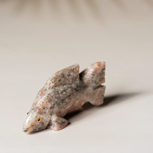 Hand-carved rose calcite fish figurine showcasing soft pink stone tones for home decor
