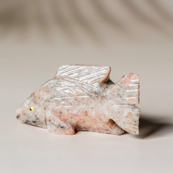 Hand-carved rose calcite fish figurine showcasing soft pink stone tones for home decor