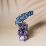 Handcrafted sodalite bird perched on natural amethyst geode decor piece