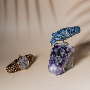 Handcrafted sodalite bird perched on natural amethyst geode decor piece