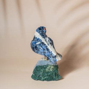 Handcrafted sodalite sparrow bird perched on natural amethyst geode base