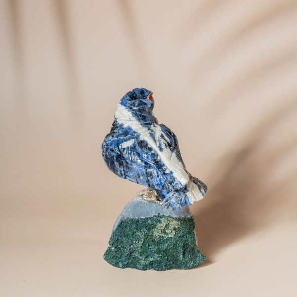 Handcrafted sodalite sparrow bird perched on natural amethyst geode base
