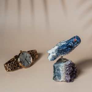 Handcrafted sodalite sparrow bird perched on natural amethyst geode base