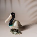 White onyx pelican figurine handcrafted from semi precious stone on natural pyrite base