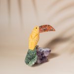 Yellow calcite pelican bird figurine handcrafted from semi precious stones on amethyst base