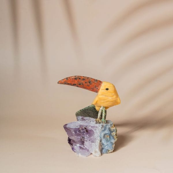 Yellow calcite pelican bird figurine handcrafted from semi precious stones on amethyst base